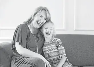  ?? Andy Jacobsohn / Tribune News Service ?? Breast cancer survivor Mary Dunkin laughs with her daughter, Lily, at their Highland Village home. Dunkin shared 10 things those with breast cancer should know as they face treatment.