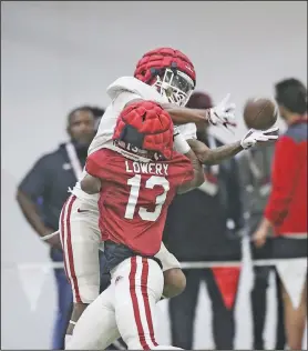  ?? Charlie Kaijo/NWA Democrat-Gazette ?? Keep your eye on the ball: Arkansas defensive back Chase Lowery (13) blocks wide receiver Quincey McAdoo (81), Saturday, April 16, 2022, during the annual spring scrimmage at the Razorback practice field in Fayettevil­le.