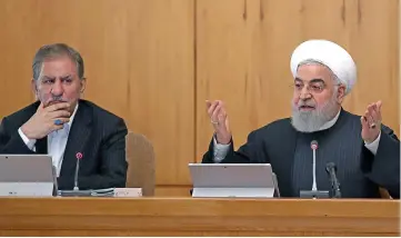  ?? (AFP) ?? President Hassan Rouhani (right) chairs a Cabinet meeting in the presence of Vice President Eshaq Jahangiri (left), in Tehran on Wednesday