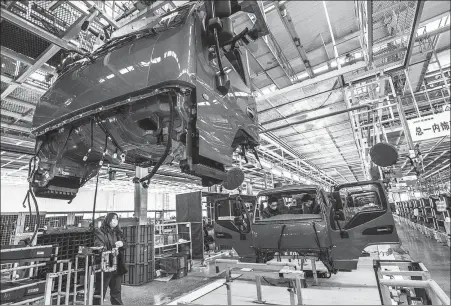  ?? WANG JILIN / FOR CHINA DAILY ?? Employees work at a truck maker’s assembly line in Weifang, Shandong province, on Feb 11.