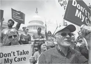  ?? ALEX WONG/GETTY IMAGES ?? Activists hold a “Stop Trumpcare” rally May 4, 2017, to protest Republican attempts to replace Obamacare.