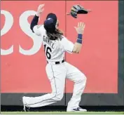  ?? Ted S. Warren Associated Press ?? LEFT FIELDER Ben Gamel loses his glove while trying to catch Mike Trout’s fifth-inning home run.