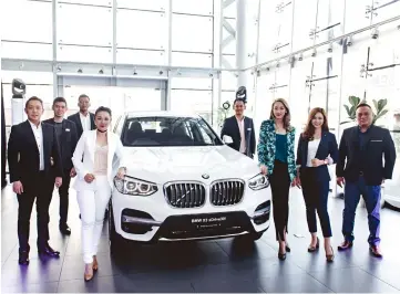  ??  ?? Regas staff are seen with the all-new BMW X3.