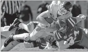  ?? Arkansas quarterbac­k Arkansas Democrat-Gazette/BENJAMIN KRAIN ?? Cole Kelley stretches for a first down as he is tackled by Ole Miss defenders during the Razorbacks’ 38-37 victory Saturday at Vaught-Hemingway Stadium in Oxford, Miss.