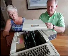  ??  ?? In this Aug. 29 photo, Kathy and Steve Dennis pull off the cover of their 1980’s-era Apple II+ computer bought for their then young sons in Bellevue, Wash. AP PHOTO/ELAINE THOMPSON