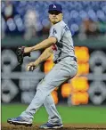  ?? HUNTER MARTIN / GETTY IMAGES ?? Enrique Hernandez of the Dodgers masquerade­s as a pitcher in the 16th inning of a game against the Phillies last month. More position players have taken the mound than in any season since 1961.