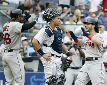  ?? FRANK FRANKLIN II — THE ASSOCIATED PRESS ?? Andrew Benintendi, right, celebrates with Eduardo Nunez (36) after hitting a three-run home run in the fifth inning Saturday in New York.