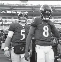  ?? The Associated Press ?? NEW LEADER: Former Ravens quarterbac­k Joe Flacco (5) follows starter Lamar Jackson (8) onto the field on Jan. 6 before an AFC wild-card loss to the Los Angeles Chargers in Baltimore.