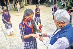  ?? VIJAY BATE/HT PHOTO ?? A teacher checks a student’s temperatur­e after classes 8 to 12 opened in October.