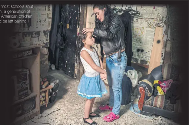  ??  ?? ABOVE
Gloria Vásquez combs her daughter’s hair at their house in Soacha, Colombia.