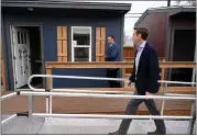  ?? HELEN H. RICHARDSON — THE DENVER POST ?? Denver Mayor Mike Johnson walks up a wheelchair ramp to check out one of the tiny homes at the new Overland Park micro-community in Denver on Monday.