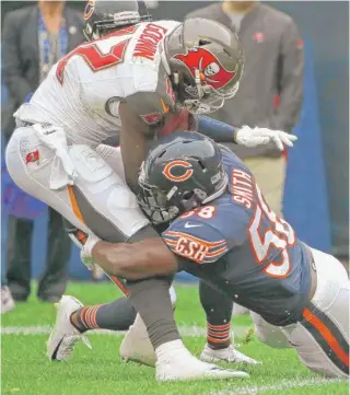  ?? GETTY IMAGES ?? Linebacker Roquan Smith (tackling Bucs receiver Chris Godwin on Sunday) still is getting acclimated to Vic Fangio’s defense after missing the preseason and most of training camp.