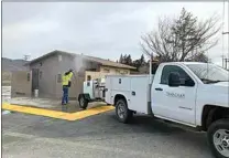  ?? COURTESY OF TVRPD ?? A city of Tehachapi staffer cleans up after a building at Meadowbroo­k Park was vandalized with graffiti on Jan. 24.