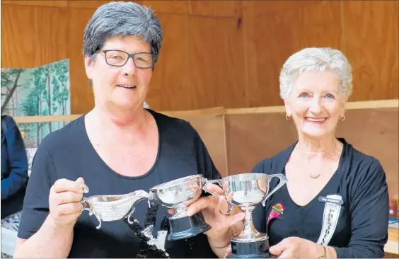  ?? Photos: Christine McKay ?? Diane Bowie, winner of the Warrington Trophy for the most points in the cooking and preserves section of the Dannevirke and Districts A&amp;P Show, along with the Grant Cup for bread, the Keith and Ann Smith Cup for best sponge sandwich, with show vice president Pam Henricksen. Diane was also placed first with her chocolate truffles and chocolate muffins.