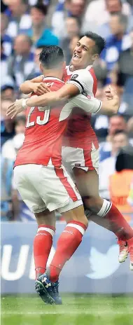  ??  ?? Arsenal’s Alexis Sánchez (right) celebrates with Arsenal’s Granit Xhaka after scoring the opening goal during the English FA Cup final against Chelsea at the Wembley Stadium in London yesterday. Arsenal won 2-1.