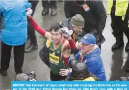  ?? — AFP ?? BOSTON: Yuki Kawauchi of Japan celebrates after crossing the finish line as the winner of the 2018 and 122nd Boston Marathon for Elite Men’s race with a time of 2:15:58. in Boston, Massachuse­tts.