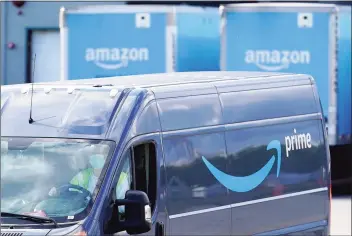  ?? Associated Press ?? An Amazon Prime logo on the side of a delivery van as it departs an Amazon Warehouse location in Dedham, Mass., in October. Online shopping has been a lifeline for many as the virus pandemic shuttered stores and kept people at home.