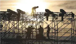  ??  ?? WASHINGTON: This photo taken on Jan 12, 2017 shows workers as they prepare the stage in front of the Lincoln Memorial. The US economy continued to pump out new jobs in January, adding 227,000 positions, while the unemployme­nt rate rose a tenth to 4.8...