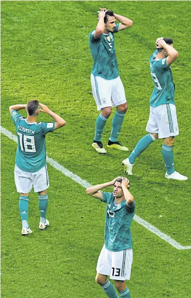  ??  ?? ABOVE Germany players react after losing to South Korea at the World Cup.