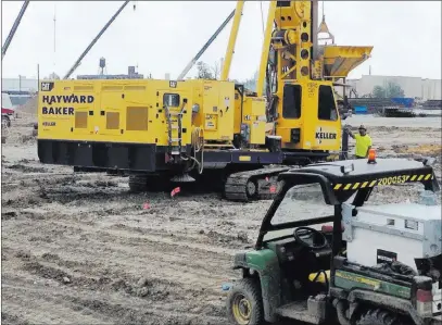  ?? Corey Williams ?? The Associated Press Heavy machinery clears land July 19 at the Interstate 94 Industrial Park in Detroit. Auto parts supplier Flex-n-gate is expected to bring 750 jobs to Detroit when it completes its 350,000-square-foot plant at the industrial park.