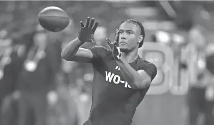  ?? KIRBY LEE/USA TODAY ?? Former Texas wide receiver Adonai Mitchell goes through drills at this past weekend's NFL combine. Mitchell, one of 11 members of the 2023 Texas team at the combine, strengthen­ed his case as a first-round pick.