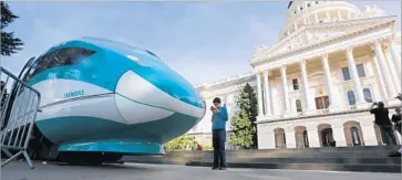  ?? Rich Pedroncell­i AP ?? A MOCK-UP of a high-speed train is displayed at the Capitol in Sacramento. The rail is scheduled for a hearing Monday by the Senate appropriat­ions committee, the last stop before the full Senate considers it.