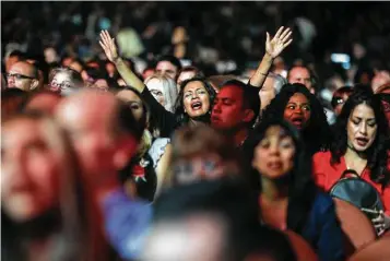  ?? Elizabeth Conley / Houston Chronicle ?? Attendees at a Night of Hope event raised their arms and their voices in worship during a music-filled show last year at the Forum in Inglewood, Calif.