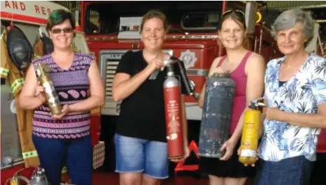  ?? Photos: Contribute­d ?? UNIQUE DONATION: Delivering the unique fire extinguish­er collection of the late Terry Devonshire to the Toowoomba Fire Brigade Museum are (from left) daughters Melissa, Joyleen and Rhonda, and wife Cheryl Devonshire.
