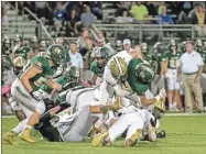  ?? Tim Godbee ?? Calhoun senior defensive end Lex Walraven, shown here driving a Blessed Trinity ballcarrie­r into the turf, and the rest of the Yellow Jackets’ defense will look to be this physical in their firstround 5A playoff matchup Friday night at home against Decatur.