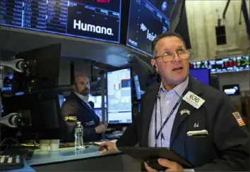  ?? Courtney Crow/New York Stock Exchange via AP ?? Trader Edward Curran, right, works Tuesday on the floor of the New York Stock Exchange. Stocks rose in afternoon trading Tuesday as talks on ending the war in Ukraine showed signs of progress.