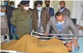  ?? — PTI ?? Union minister Jitendra Singh, accompanie­d by J&K DGP Dilbag Singh, meets with injured victims of the Mata Vaishno Devi shrine stampede at a hospital near Jammu on Saturday.