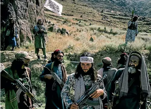  ?? WASHINGTON POST ?? Taliban fighters parade their weapons in Marawara district, Afghanista­n. Experts say the unity of the Taliban movement as a whole is difficult to gauge, but it is made up of networks that include hard line elements and more moderate leaders.