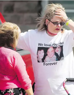  ?? PETER POWER / THE CANADIAN PRESS ?? Susan Horvath, daughter of Arpad Horvath Sr., one of Elizabeth Wettlaufer’s victims, is comforted after leaving the courthouse in Woodstock, Ont., on Thursday.