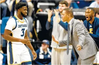  ?? STAFF FILE PHOTO BY ROBIN RUDD ?? UTC coach Lamont Paris instructs David Jean-Baptiste during a game against Wofford in February. Jean-Baptiste says Paris has been working him and his teammates hard in preseason workouts.