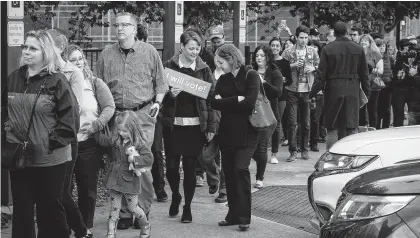  ?? Loren Elliott / Getty Images ?? People wait in line to vote at a polling place on the first day of early voting on Monday. Former judge Rudy Apodaca says voters should familiariz­e themselves with candidates and their platforms instead of just voting along party lines.