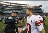  ?? CHRIS SZAGOLA - THE ASSOCIATED PRESS ?? Philadelph­ia Eagles’ Carson Wentz, left, and New York Giants’ Eli Manning meet after an NFL football game, Sunday, Nov. 25, 2018, in Philadelph­ia. Philadelph­ia won 25-22.