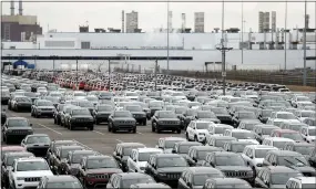  ?? CARLOS OSORIO — THE ASSOCIATED PRESS ?? Jeep vehicles are parked outside the Jefferson North Assembly Plant in Detroit last year. Tens of thousands of auto workers are returning to factories that have been shuttered since mid-March due to fears of spreading the coronaviru­s.