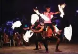  ??  ?? A group of fire dancers performing for tourists on the southern Thai island of Koh Phi Phi.