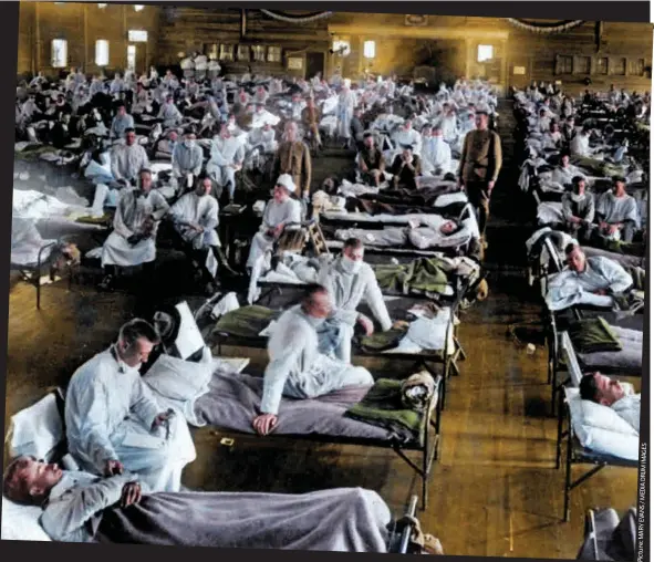  ??  ?? Victims: Soldiers lie in bed during the 1918 flu epidemic