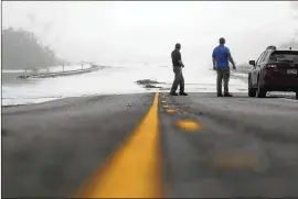  ?? ERIC GAY / ASSOCIATED PRESS ?? Motorists watch as flood waters from the Guadalupe River spill over Texas Highway 35 in Tivoli, Texas, on Sept. 1. Texas will be challenged to marshal every resource available to ensure Harvey-ravaged communitie­s can rebuild quickly.