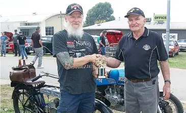  ??  ?? Les Salmon (left) with his 1924 Douglas TS, receiving his first prize trophy in the classic motorcycle section, from Rotarian John Franklin.