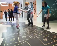  ?? BERNARD WEIL/TORONTO STAR ?? Pippa Mighton, 10, and her brother Conan, 13, play a hopscotch game that mixes the traditiona­l with interactiv­ity at digiPlaySp­ace.