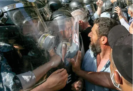  ?? EPA ?? The financial crisis in Lebanon has prompted extraordin­ary protests by account holders at many of the country’s banks