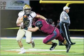  ?? RACHEL WISNIEWSKI/FOR DIGITAL FIRST MEDIA ?? La Salle’s running back junior Manny Quiles (left) is tackled by St. Joe’s Prep’s linebacker, senior Phil O’Connor Friday night.