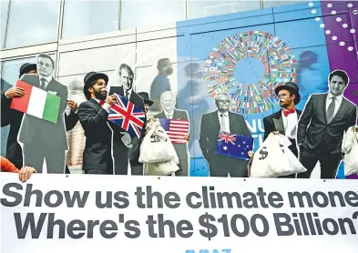  ?? ?? Activistas reclaman a líderes sus promesas incumplida­s contra el cambio climático, en el FMI