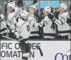  ?? Associated Press ?? Kings center Anze Kopitar (foreground) is congratula­ted by teammates after scoring against the San Jose Sharks during the first period on Tuesday in San Jose.