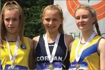  ??  ?? Erin Taheny, centre, from Collooney won two National titles recently in the U15 100m and 200m.
