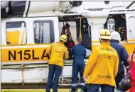  ?? Cory Rubin/The Signal ?? Paramedics work to airlift a young boy who fell into a Saugus community pool on Friday.