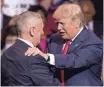  ??  ?? President-elect Donald Trump greets retired Marine Corps Gen. James Mattis, left, as he announces him as his pick for Defense secretary at a rally in Fayettevil­le, N.C., Tuesday. AP