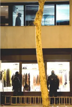  ??  ?? A Malian man (top) who allegedly has taken a hostage woman stands inside the consulate of Mali in Barcelona as ‘Mossos d’Esquadra’ (Catalan police) officers prepare to intervene. — AFP photo